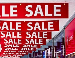 sale "Sale" signs hanging from a ceiling