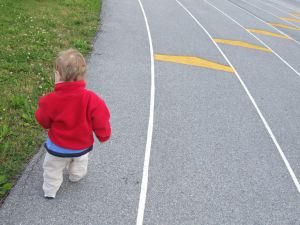 small child at the starting line of a track